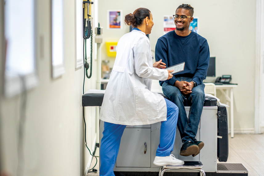 A young adult talking to a doctor.