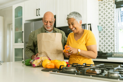 man and woman emptying grocery bag