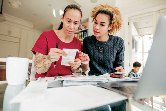 Two adults looking at a receipt.